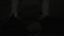 a man with a beard is standing in front of a wooden door