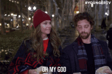 a man and a woman are standing next to each other and the man is saying oh my god