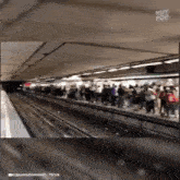 a crowd of people waiting for a train at a subway station with the caption muy pop