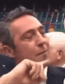 a man is making a funny face with his eyes closed