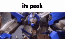 a close up of a blue robot with the words `` its peak '' written above it .
