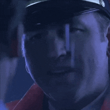 a close up of a man 's face with a hat that says jc on it