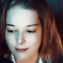 a close up of a woman 's face with long hair
