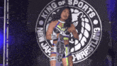 a woman is standing in front of a sign that says king of sports
