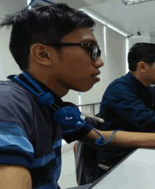 a young man wearing headphones with the letter m on it