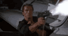 Arnold Schwarzenegger Gun GIF - Arnold Schwarzenegger Gun Firing GIFs
