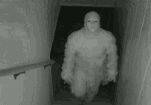 a man in a mummy costume is walking down stairs in a dark room .