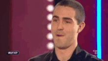 a man is making a funny face on a television show called gfvip .