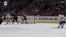 a hockey game is being played in front of an aeroplan sign