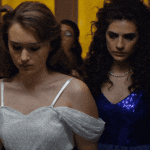 a woman in a white dress and a woman in a blue dress