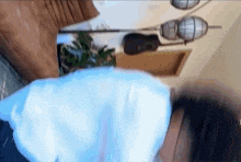 a person is laying on a couch in a living room with a lamp .