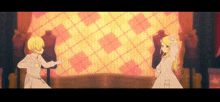 a boy and a girl are dancing in front of a checkered wall