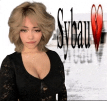 a woman in a black top stands in front of a sybau logo