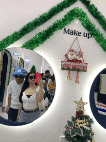 a mirror with a sign that says merry christmas on it
