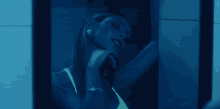 a woman is looking at herself in a mirror