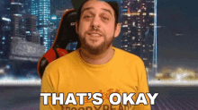 a man says that 's okay while wearing a yellow shirt