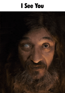 a man with a beard and a white eye has the words i see you above him