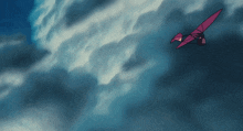 a pink airplane is flying through a cloudy blue sky