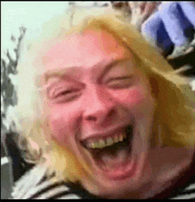 a close up of a person 's face with their mouth open and their eyes closed .