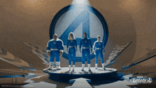 the fantastic four are standing on a stage in front of a fantastic 4 logo
