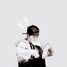 a boy in a baseball cap is eating a piece of paper with the word omg written on it