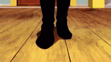 a pair of black boots on a wood floor