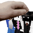 a person 's hand is holding a minecraft character 's head .