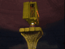 a man is in a cage on top of a hand