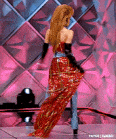 a woman in a red dress is standing on a stage .