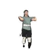 a man in a green shirt is holding a gun over his head