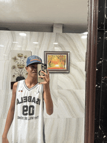 a man taking a picture of himself in a mirror wearing a jersey with the number 20