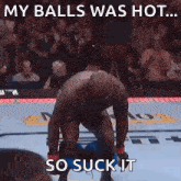 a man is kneeling down in a boxing ring with the words my balls was hot so suck it