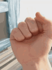 a close up of a person 's fist with their fingers closed .