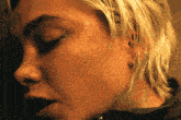 a close up of a woman 's face with earrings