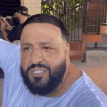 a man with a beard wearing a white shirt