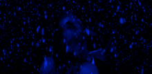 a man in a suit kisses a woman in a dark room