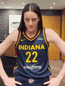 a woman wearing a jersey that says indiana 22 salesforce