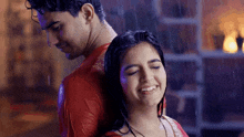 a man and a woman are standing in the rain .