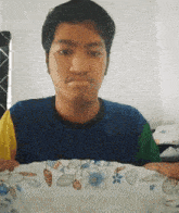 a man in a colorful shirt is holding a plate with a floral pattern