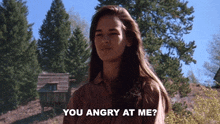 a woman says " you angry at me " in front of a cabin in the woods