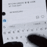 a person is typing on a cell phone with a message that says bitch lmaoo at this shit