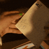 a person holding an envelope with the name louis campbell on it