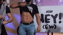two men are standing in front of a sign that says " hey "