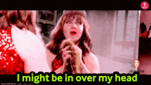 a woman in a red dress is holding a furry animal with the words i might be in over my head above her