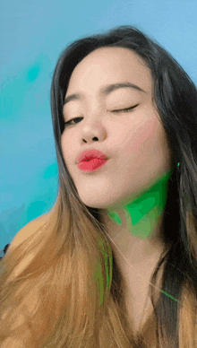 a woman with red lipstick on her lips looks at the camera
