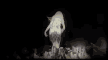 a woman is standing on a stage in front of a crowd .