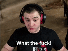 a man wearing headphones and a black shirt says what the fuck !