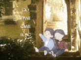 two girls are sitting on a set of stairs with the words gio danh canh hong written on the wall behind them
