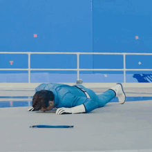 a man in a blue suit and white gloves is laying on the ground