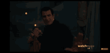 a man reaches out towards another man with the words watchmojo uk below him